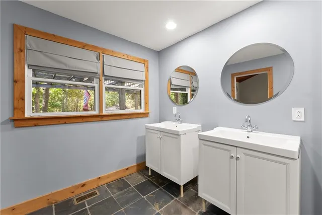 a bathroom with a toilet sink and mirror