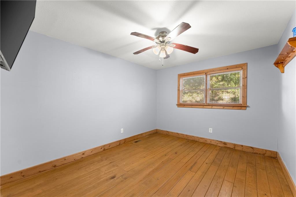 773 Shorewood Circle Toccoa, GA 30577 - Photo 28 of 39 a view of an empty room with wooden floor and a chandelier fan
