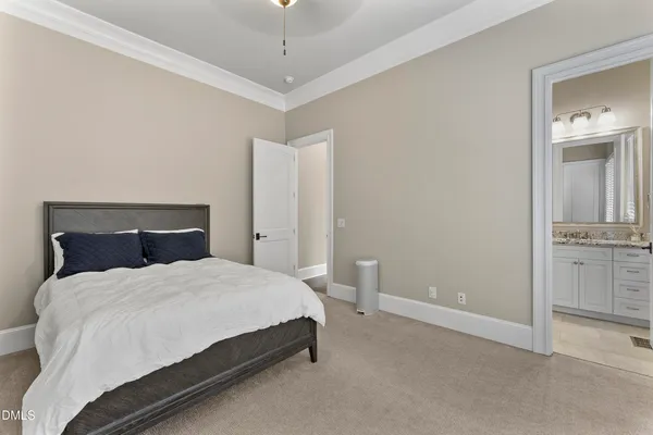 a spacious bedroom with a large bed and a large window