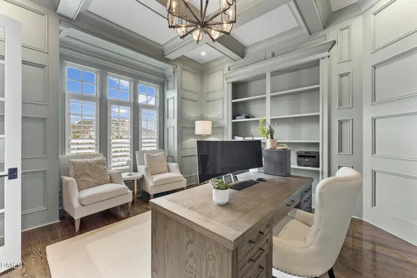 a view of a dining room with furniture and chandelier