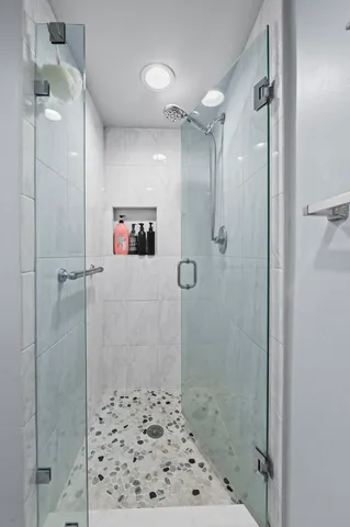 a bathroom with a shower and a sink