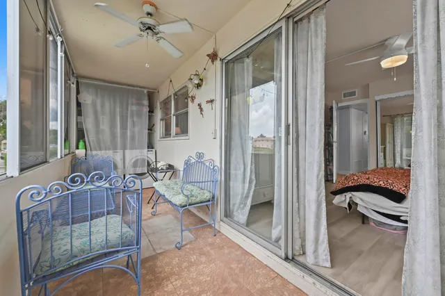 a living room with furniture and a glass door