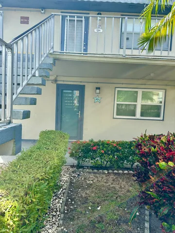 a house with a flower garden in front of it