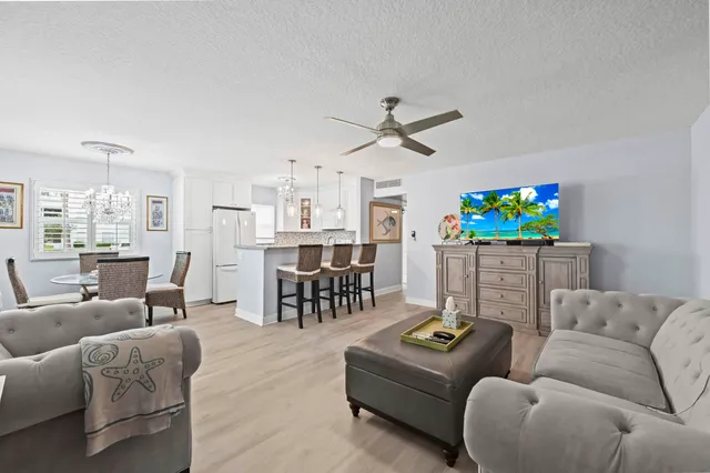 a living room with furniture and kitchen view
