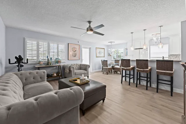 a living room with furniture dining area and a large window