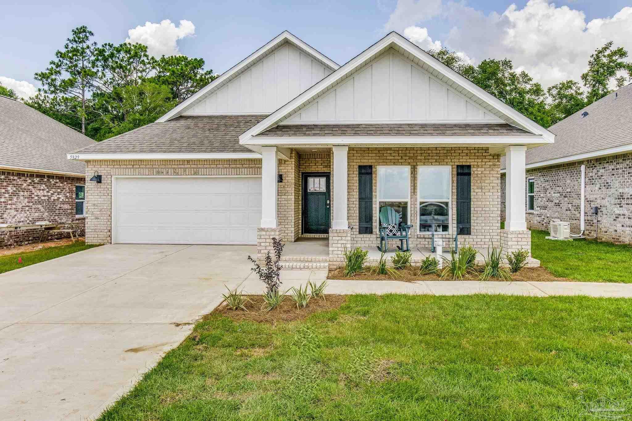 a front view of house with yard and outdoor seating