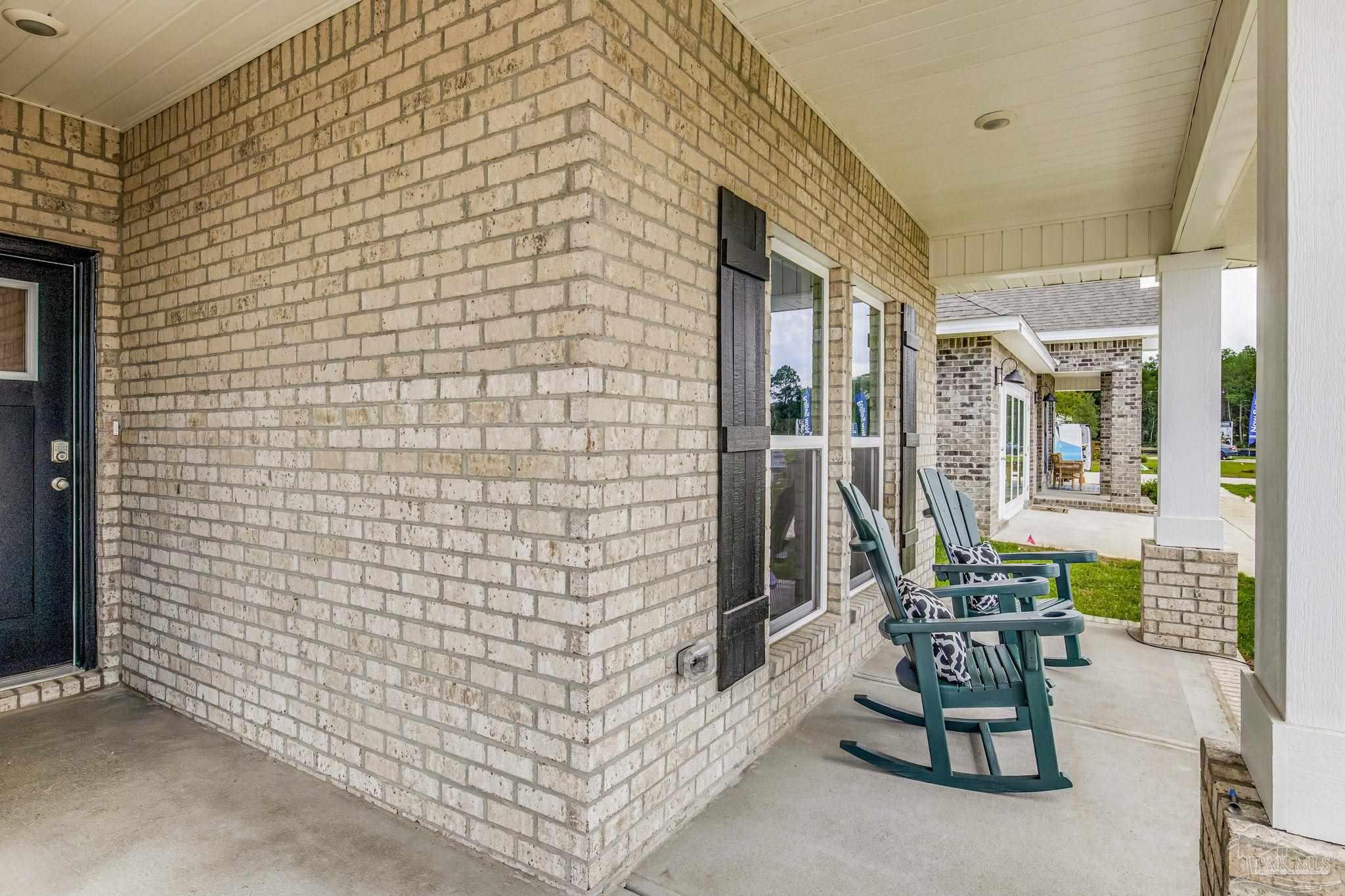 9793 Windy Hill Road Pensacola, FL 32526 - Photo 2 of 36 a patio with table and chairs and potted plants