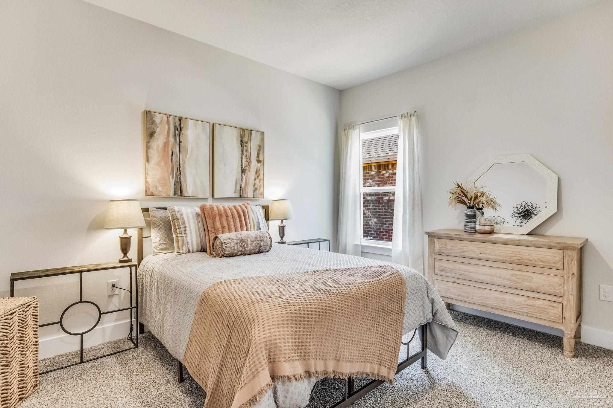 9793 Windy Hill Road Pensacola, FL 32526 - Photo 23 of 36 a bedroom with a large bed and windows