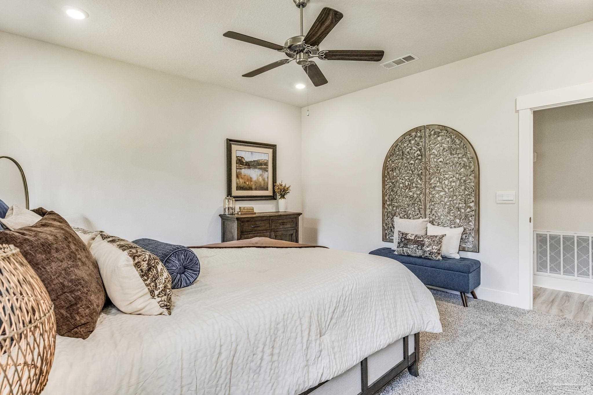 9793 Windy Hill Road Pensacola, FL 32526 - Photo 30 of 36 a bedroom with a bed and a chandelier