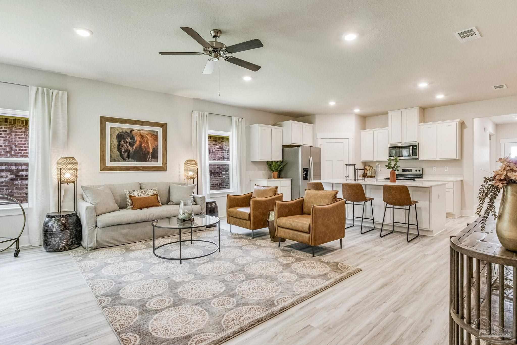 9793 Windy Hill Road Pensacola, FL 32526 - Photo 5 of 36 a living room kitchen with furniture and a wooden floor