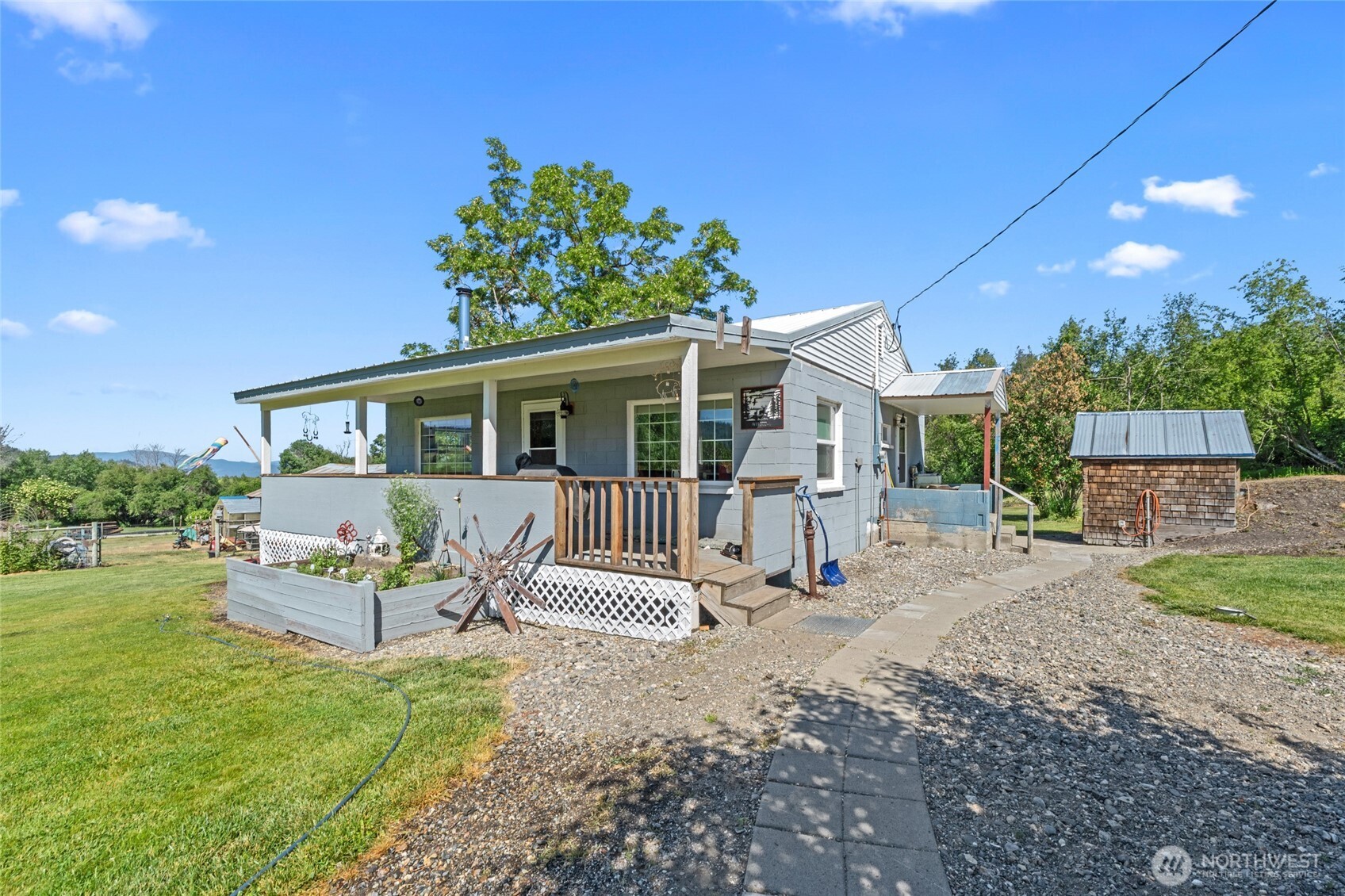 5787 Fruitland Valley Road Fruitland, WA 99129 - Photo 6 of 29 a view of a house with backyard and a tree