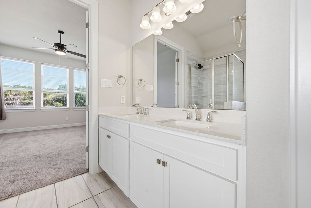 2032 Base Burner Path Leander, TX 78641 - Photo 20 of 34 Bathroom featuring a dual vanity with white cabinetry, light-colored countertops, and brushed nickel fixtures