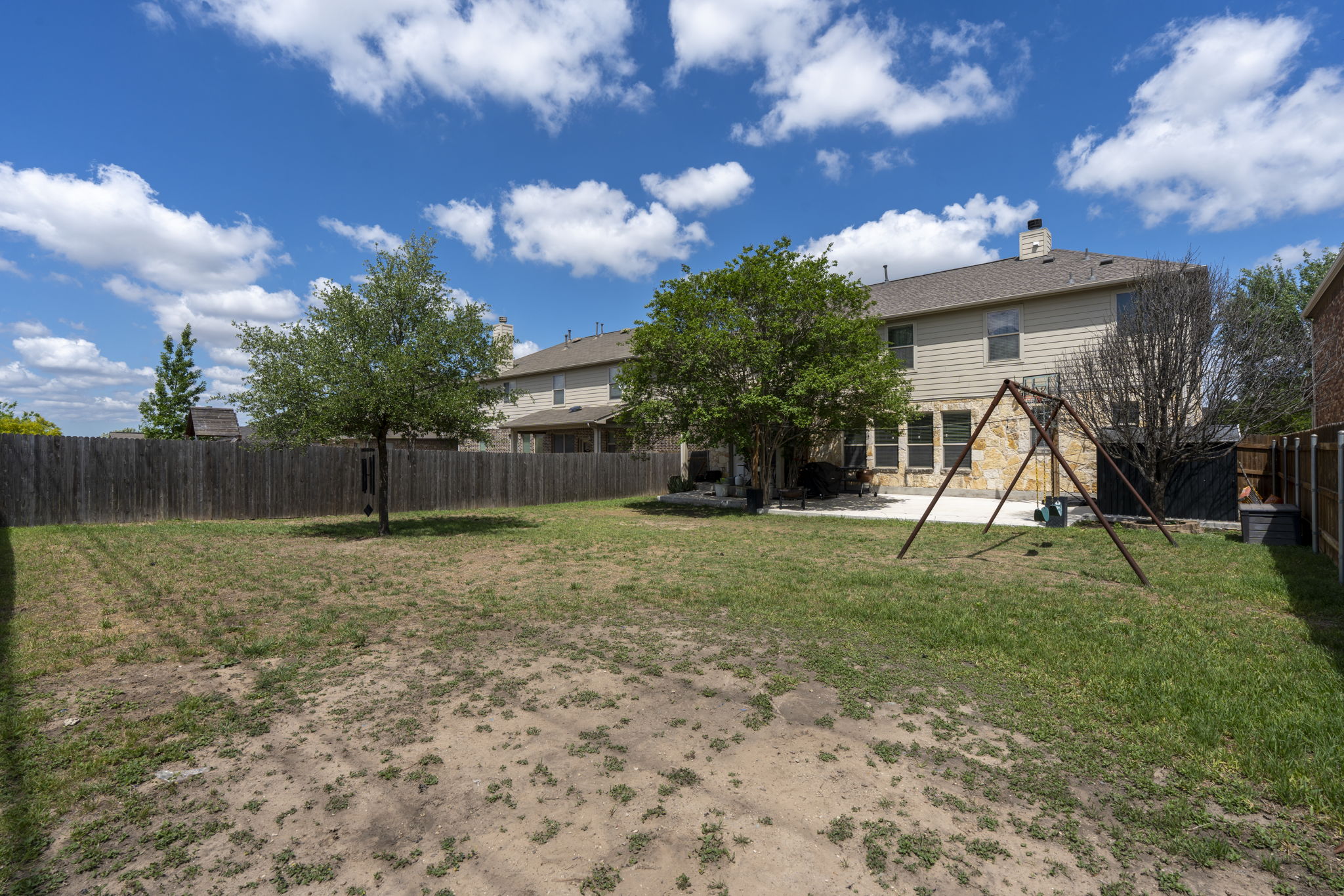 227 Sandstone Trail Buda, TX 78610 - Photo 26 of 33 Expansive backyard with a full privacy fence and mature trees