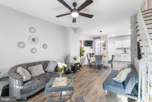 a living room with furniture and kitchen view