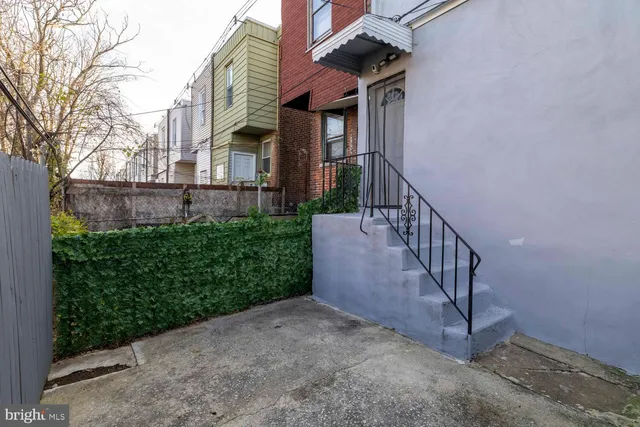a view of a house with brick walls