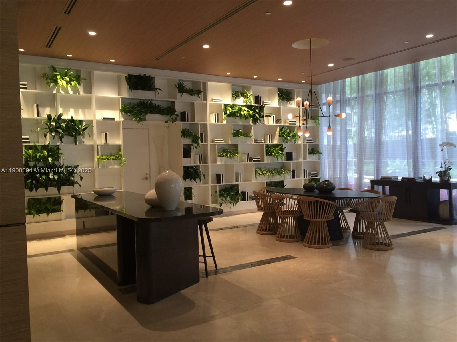 45 Southwest 9th Street, Unit 1402 Miami, FL 33130 - Photo 11 of 19 a lobby with furniture and potted plants