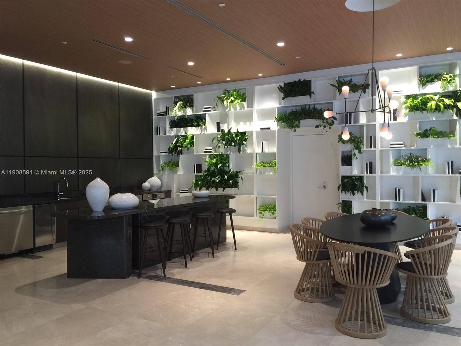 45 Southwest 9th Street, Unit 1402 Miami, FL 33130 - Photo 12 of 19 a kitchen with a table chairs and a dining table