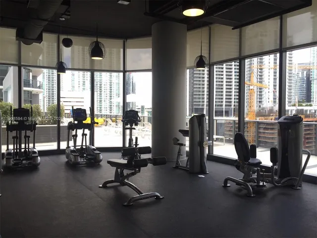 a lobby with furniture and potted plants