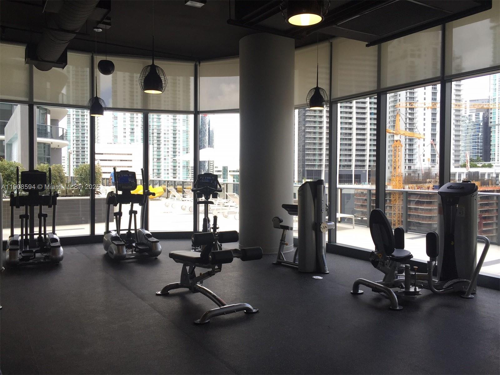45 Southwest 9th Street, Unit 1402 Miami, FL 33130 - Photo 10 of 19 a view of a room with gym equipment