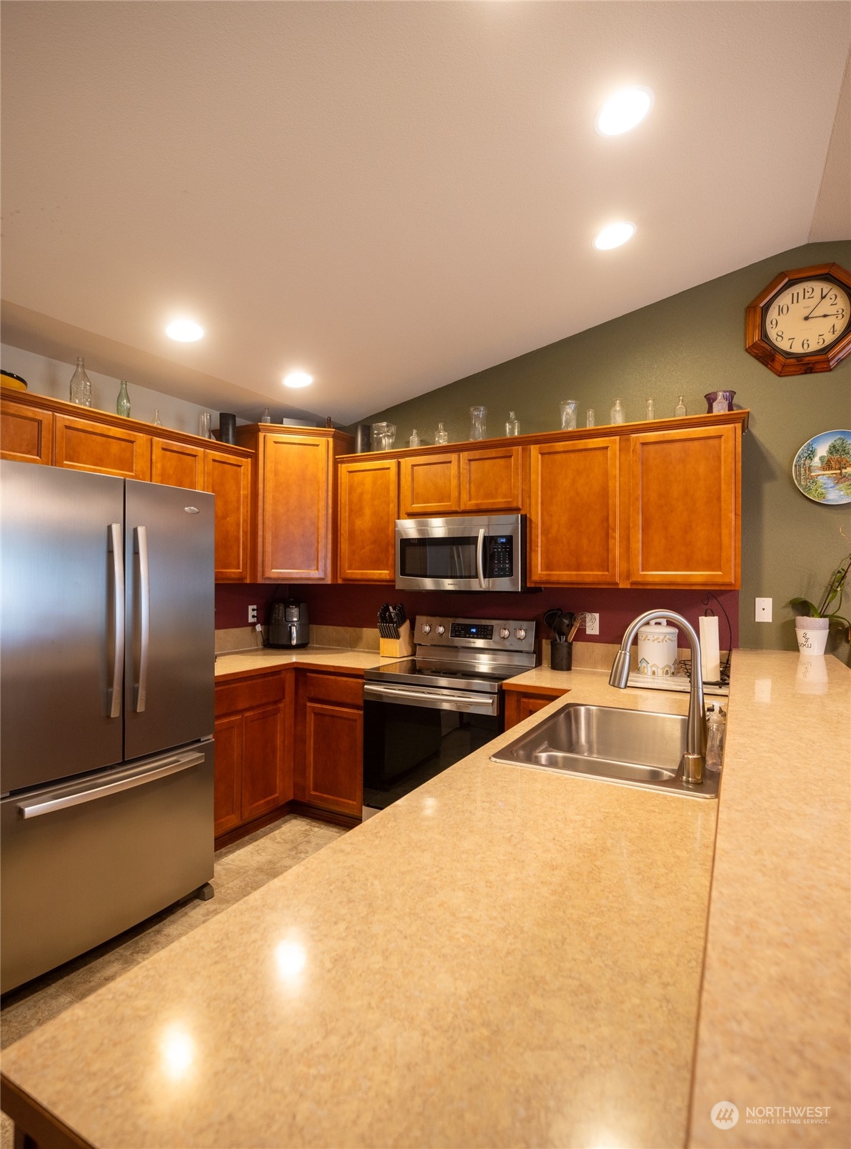 18037 Prairie Pointe Lane Southwest Rochester, WA 98579 - Photo 6 of 22 a kitchen with granite countertop a refrigerator and a sink