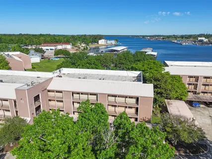 an aerial view of a building with garden space and ocean view