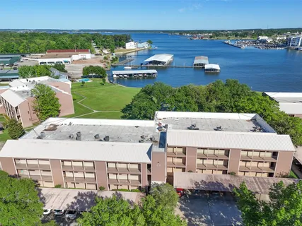 an aerial view of a house with garden space and ocean view