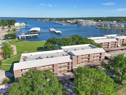an aerial view of a house with a garden and lake view
