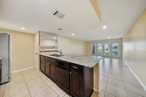 a kitchen with a stove a sink and a refrigerator