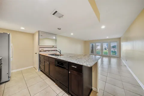 a kitchen with a stove a sink and a refrigerator