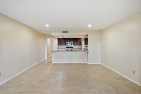 a view of a kitchen with a sink and a refrigerator