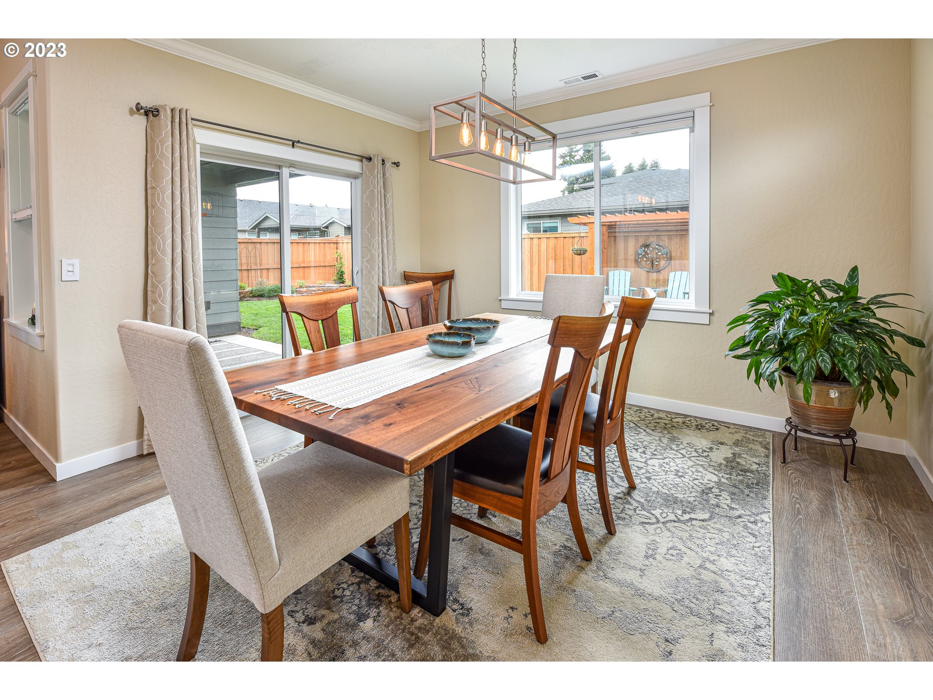 878 Tyson Lane Eugene, OR 97404 - Photo 15 of 39 a view of a dining room with furniture window and wooden floor