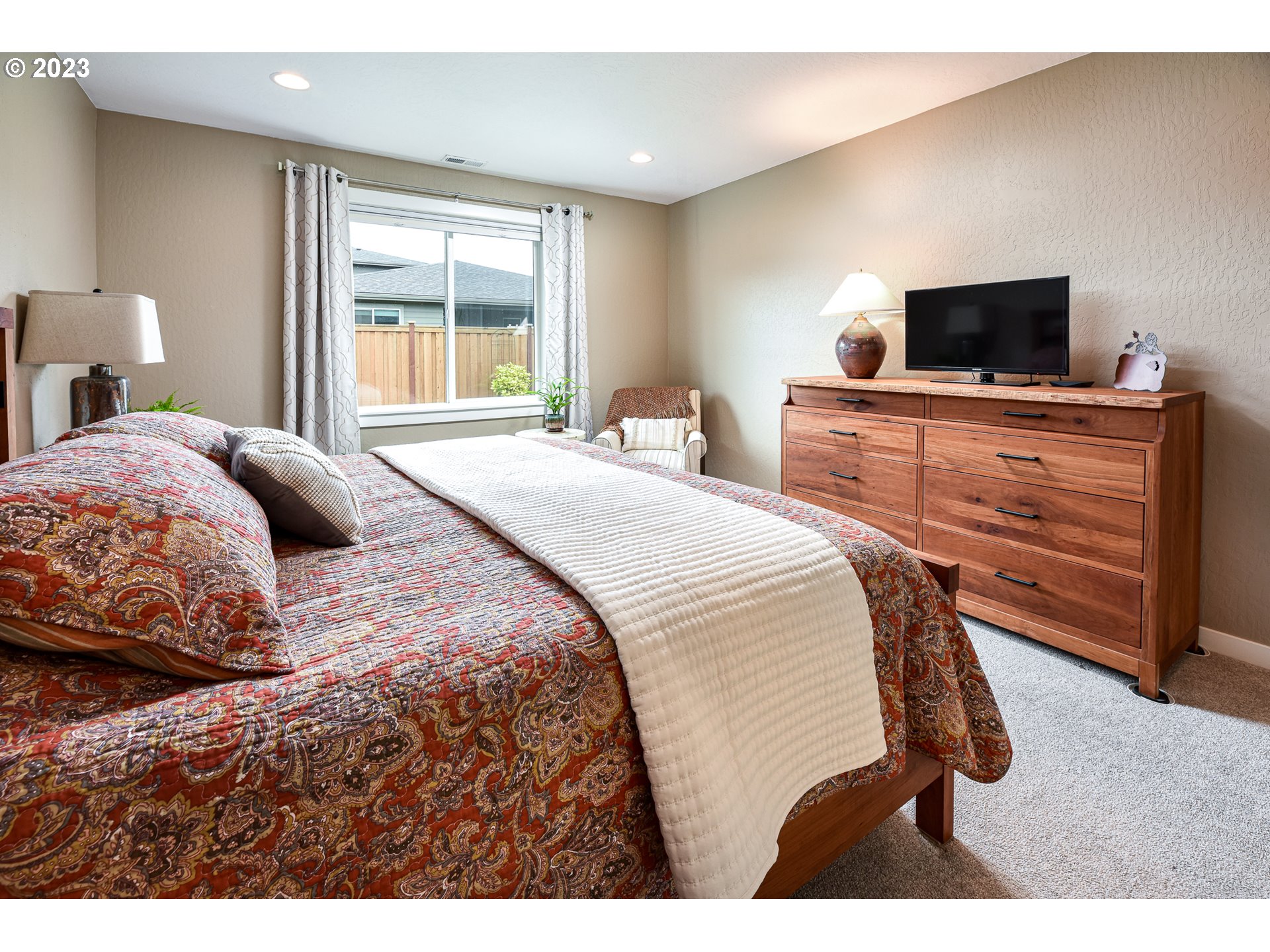 878 Tyson Lane Eugene, OR 97404 - Photo 18 of 39 a bedroom with a bed and flat screen tv