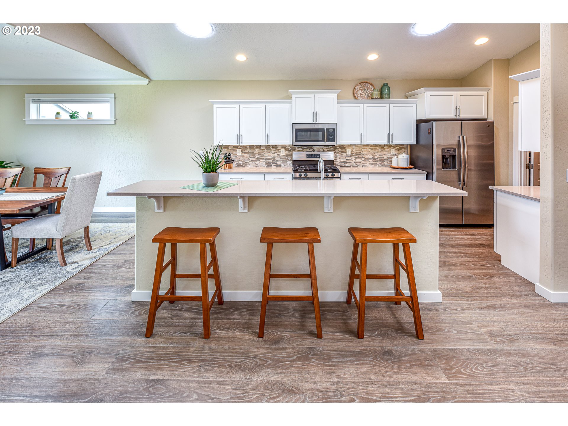 878 Tyson Lane Eugene, OR 97404 - Photo 8 of 39 a kitchen with stainless steel appliances granite countertop a table chairs sink and cabinets