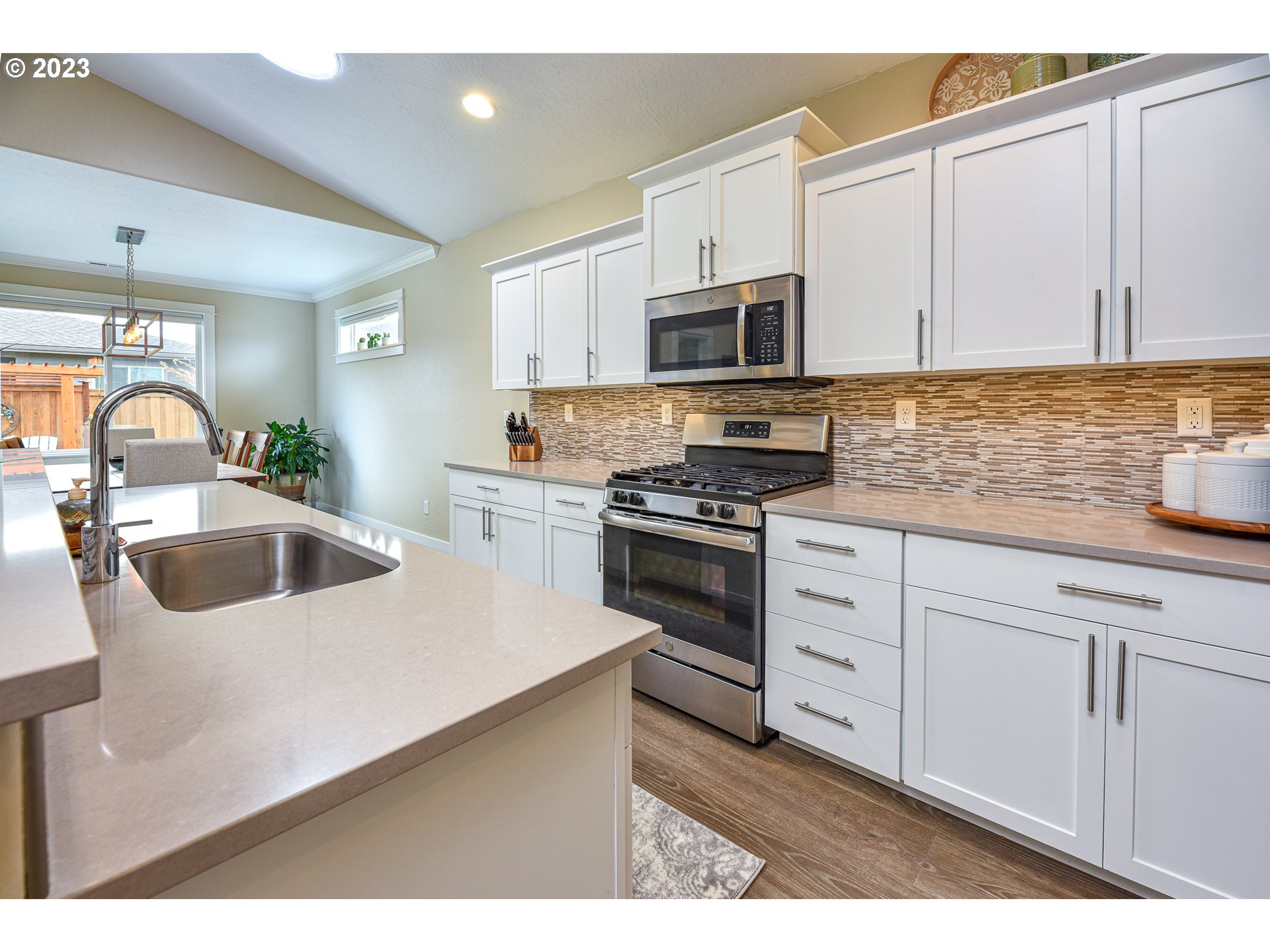 878 Tyson Lane Eugene, OR 97404 - Photo 9 of 39 a kitchen with stainless steel appliances granite countertop a sink a stove and a microwave