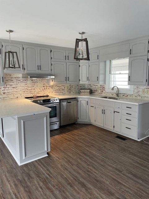 3125 Buffalo Road Lawrenceburg, TN 38464 - Photo 17 of 22 a kitchen with stainless steel appliances granite countertop a stove and white cabinets