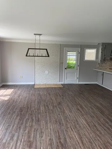 a kitchen with stainless steel appliances a sink cabinets and wooden floor