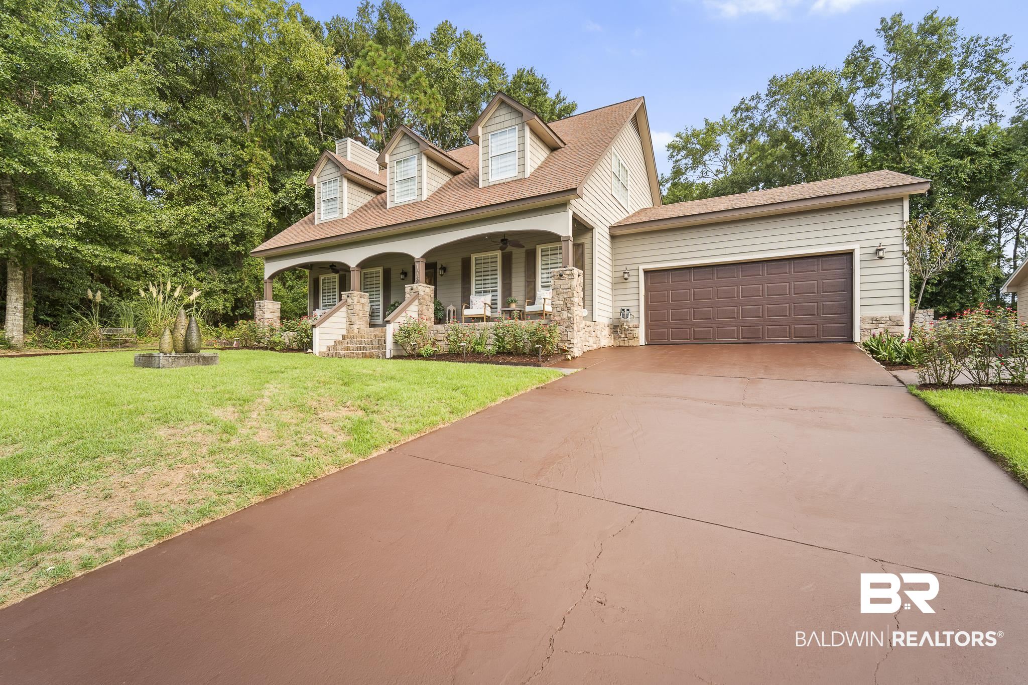 178 Lakeview Loop Daphne, AL 36526 - Photo 40 of 43 Cape cod home with a porch, stone siding, concrete driveway, and a garage