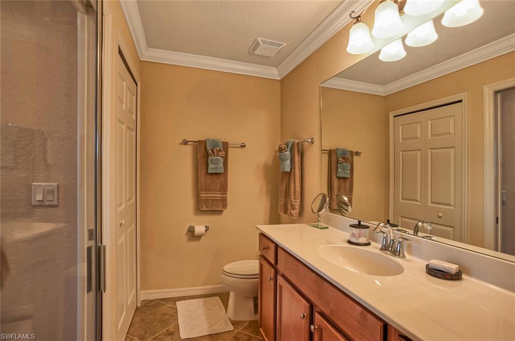 9727 Acqua Court, Unit 425 Naples, FL 34113 - Photo 12 of 26 a bathroom with a sink a toilet and shower