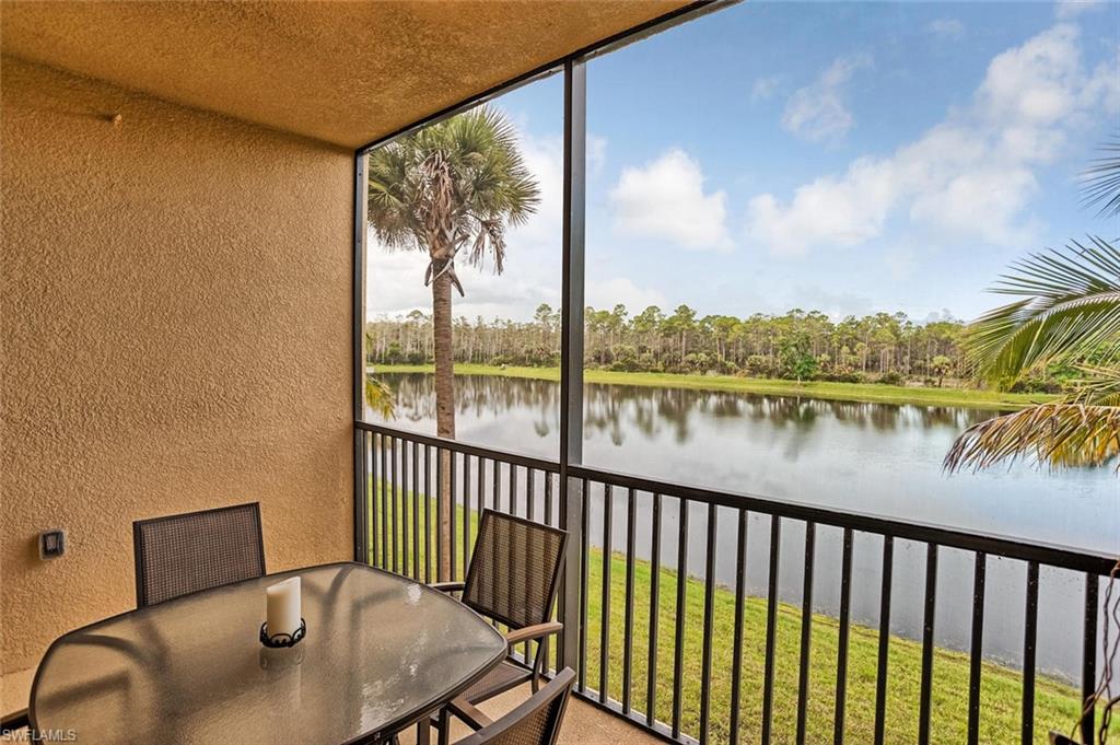 9727 Acqua Court, Unit 425 Naples, FL 34113 - Photo 16 of 26 a balcony with table and chairs