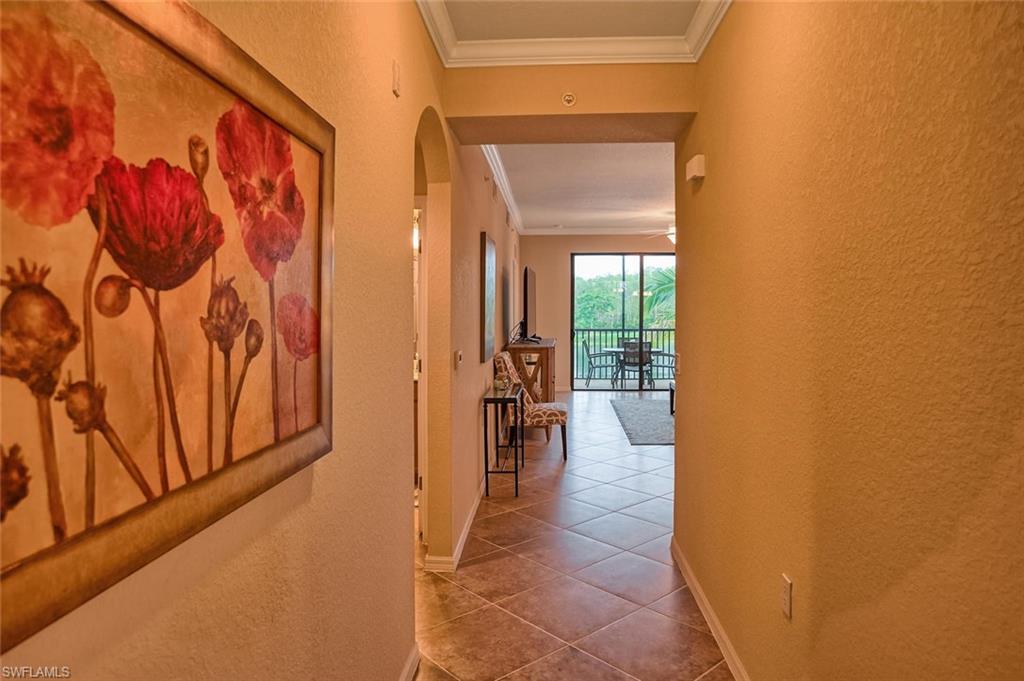 9727 Acqua Court, Unit 425 Naples, FL 34113 - Photo 3 of 26 a view of a hallway with wooden shelves