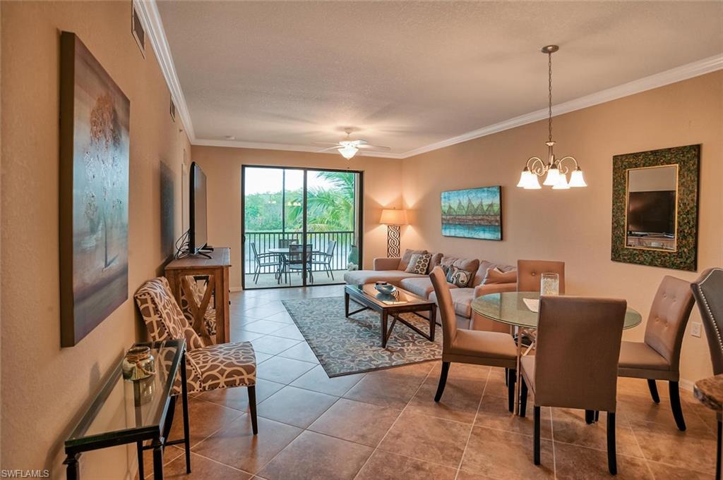 9727 Acqua Court, Unit 425 Naples, FL 34113 - Photo 4 of 26 a view of a livingroom with furniture window and wooden floor