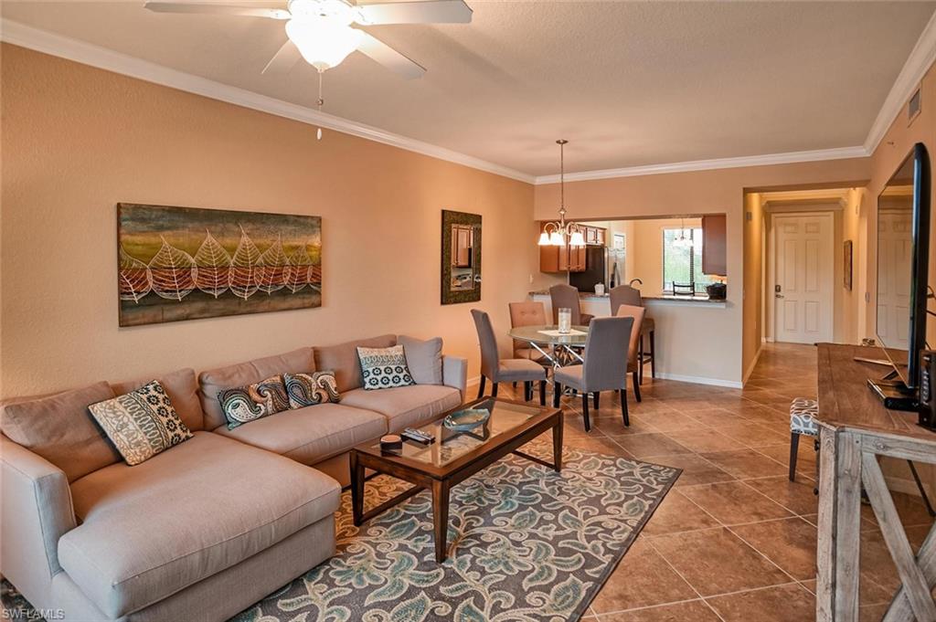 9727 Acqua Court, Unit 425 Naples, FL 34113 - Photo 8 of 26 a living room with furniture and a flat screen tv