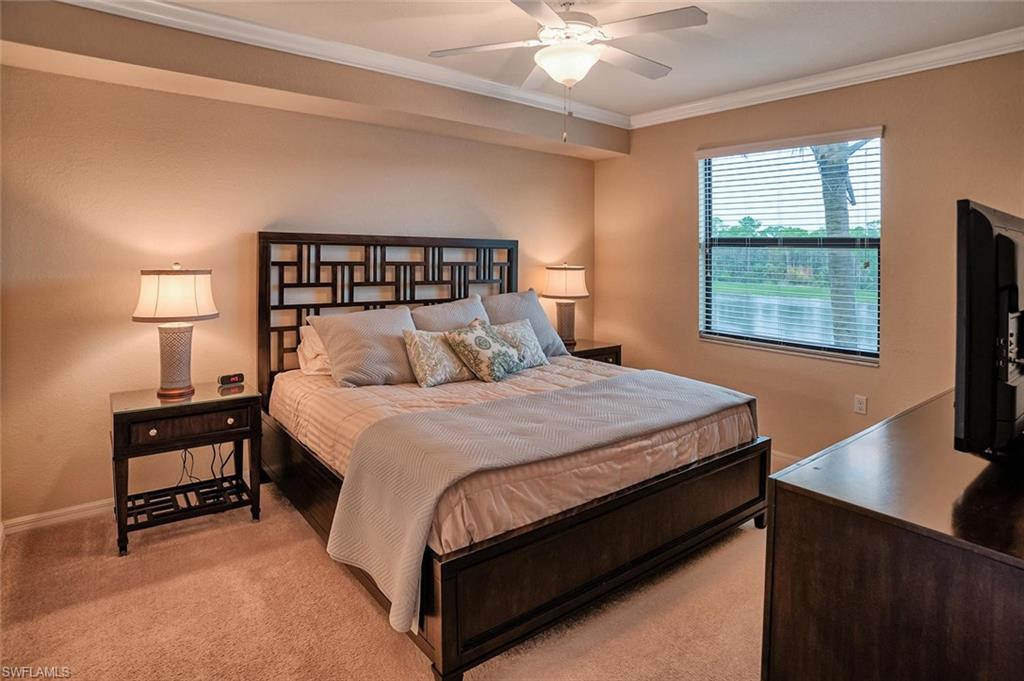 9727 Acqua Court, Unit 425 Naples, FL 34113 - Photo 9 of 26 a bedroom with a bed tv and a window