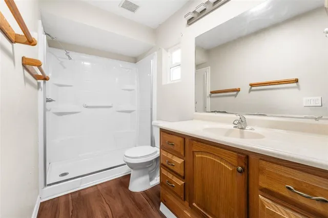 a bathroom with a sink toilet a mirror and shower