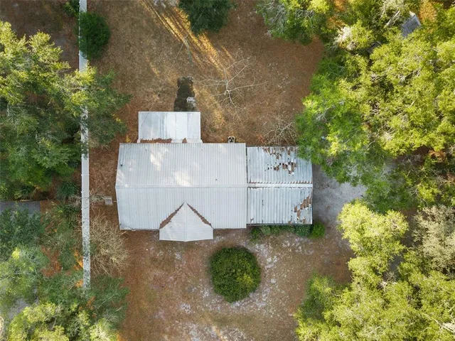 an aerial view of a house with yard
