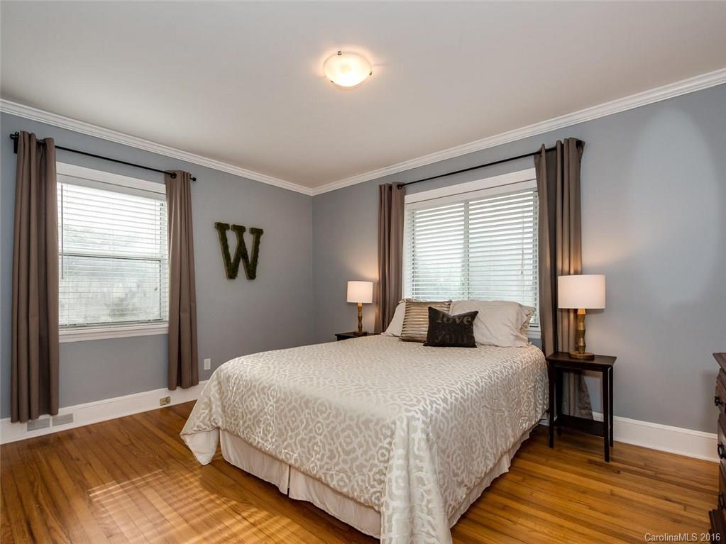 935 Scaleybark Road Charlotte, NC 28209 - Photo 12 of 17 a bedroom with a bed and a night stand