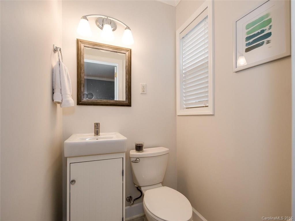 935 Scaleybark Road Charlotte, NC 28209 - Photo 13 of 17 a bathroom with a toilet sink and mirror