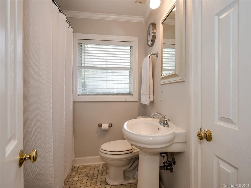 935 Scaleybark Road Charlotte, NC 28209 - Photo 14 of 17 a bathroom with a sink toilet and a mirror