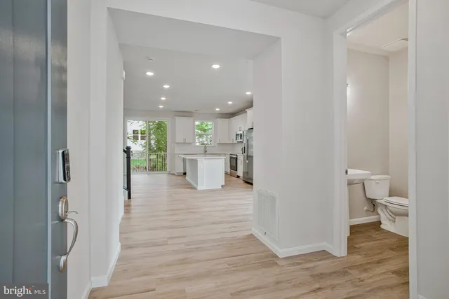 a view of a hallway with wooden floor