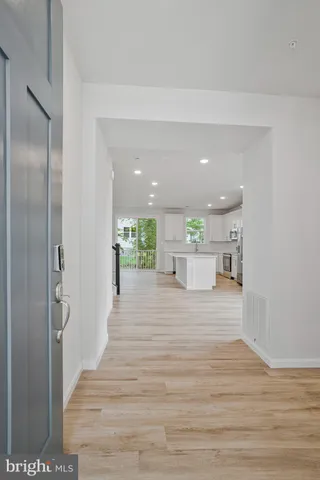 a view of a hallway with wooden floor